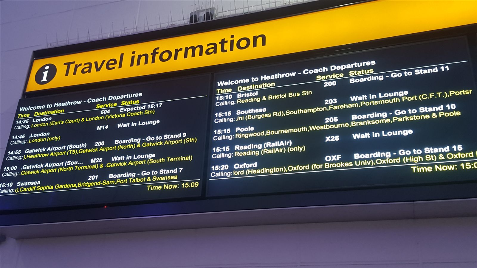 Close-up of departure boards showing times, destinations, service numbers and boarding status